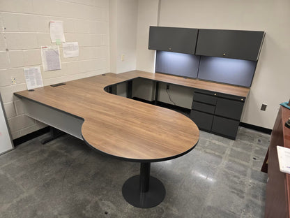 Custom steel desk with dark pedestal storage in corporate office setting by gen2