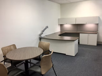 Custom office desk with height-adjustable base, overhead storage, and dark finish by gen2