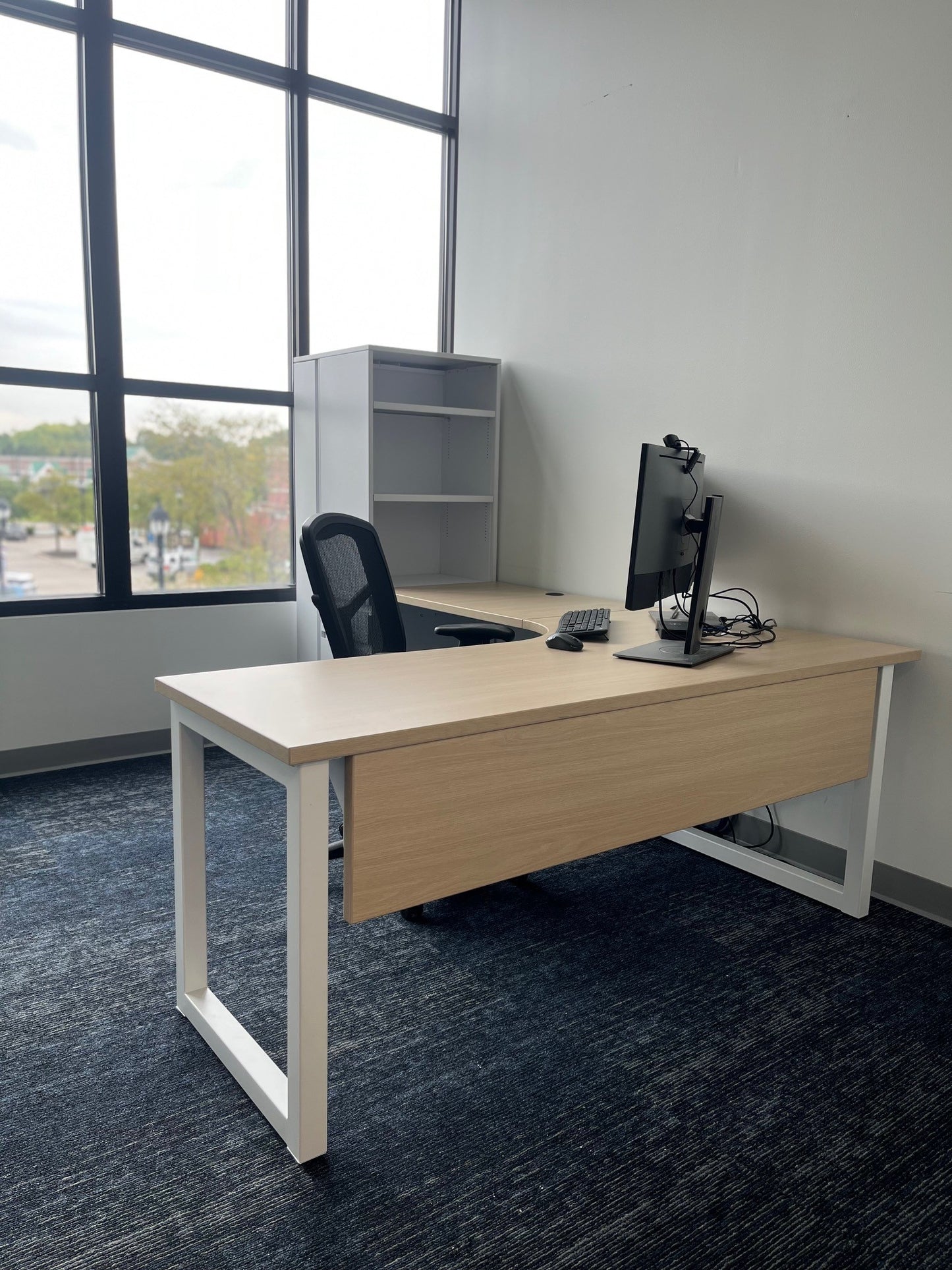 Custom height-adjustable desk with dual monitor arm and overhead cabinets by gen2