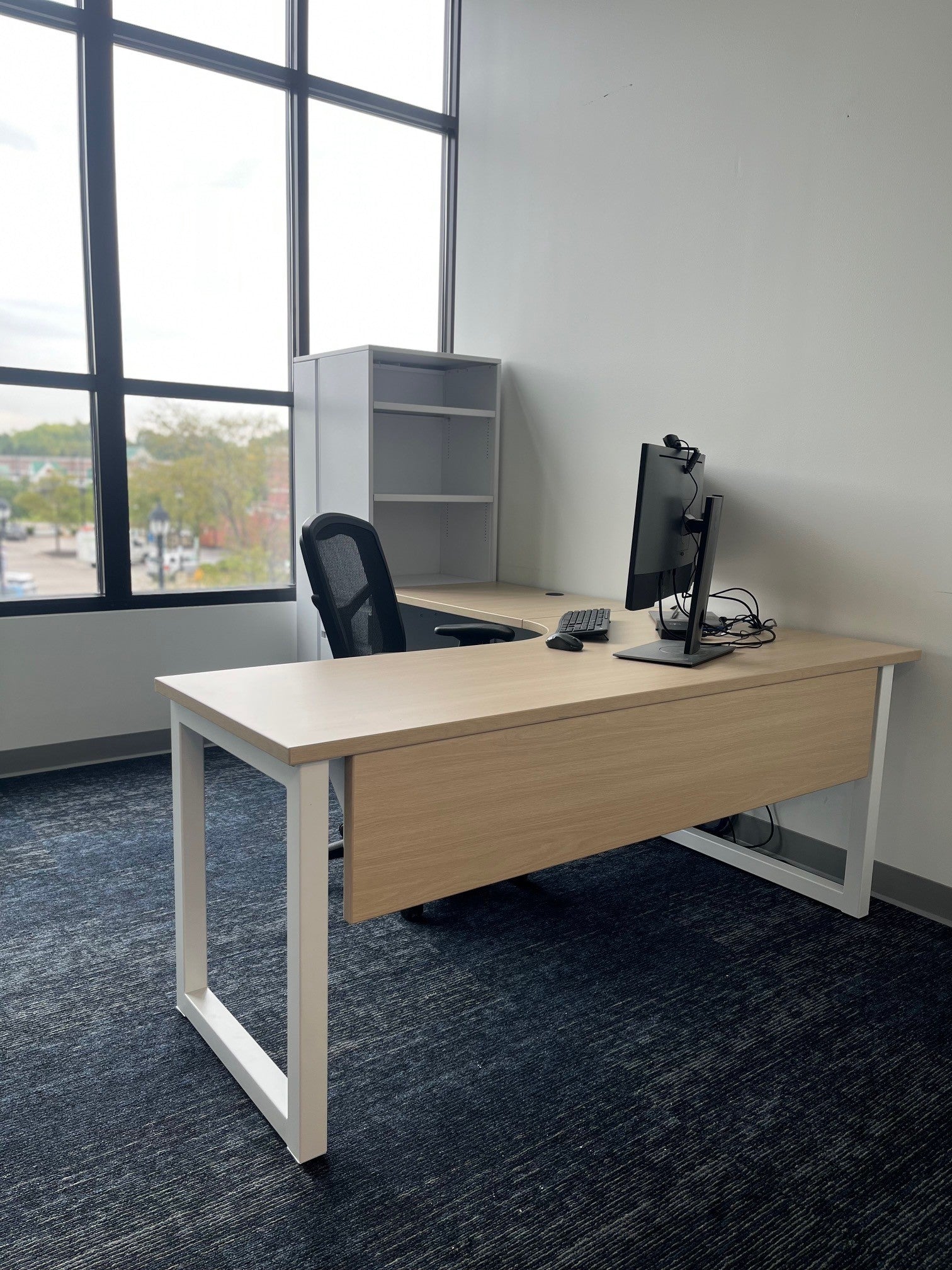 Custom height-adjustable desk with dual monitor arm and overhead cabinets by gen2
